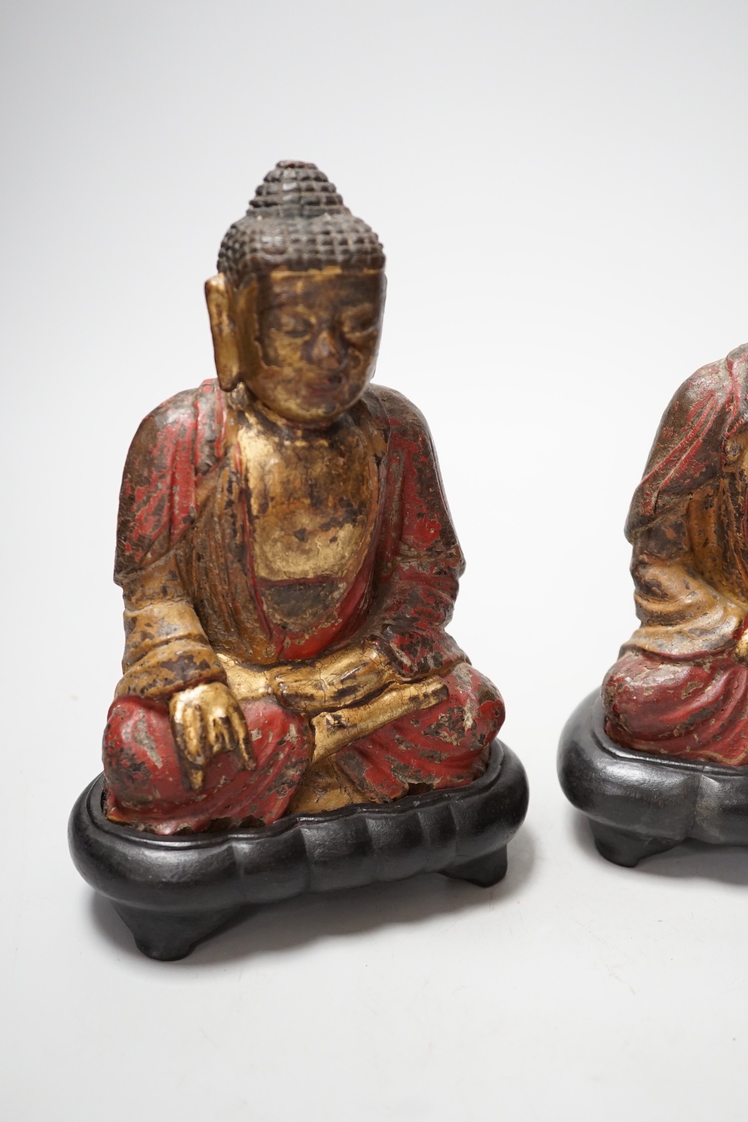 A set of three Chinese polychrome lacquered wood seated figures of Buddha, 19cm